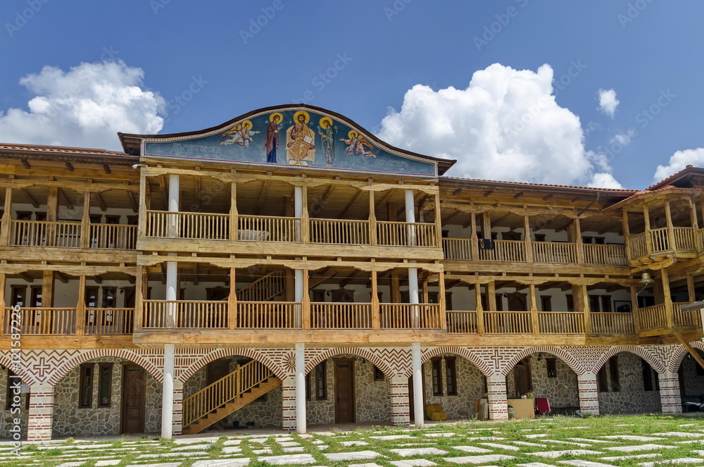 Fototapeta premium View of inner part yard with new monastic house in restored Montenegrin or Giginski monastery St. St. Cosmas and Damian, mountain Kitka, Breznik, Pernik region, Bulgaria