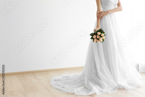 Fotografie Bride in beautiful dress holding wedding bouquet
