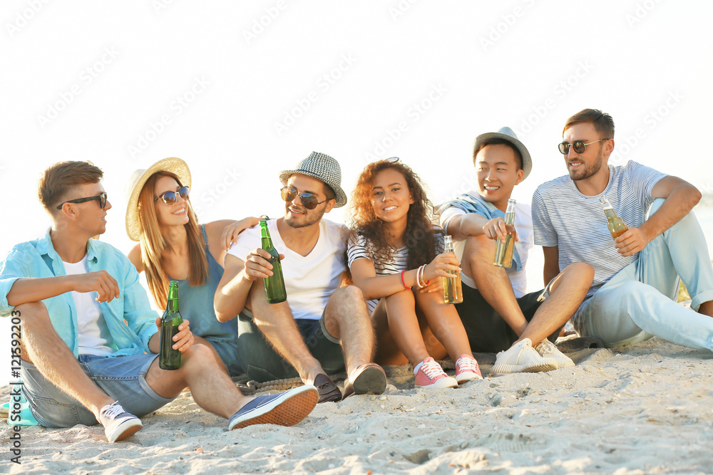Group of friends hanging out with beer at the beach Group of friends hanging out with beer at the beach