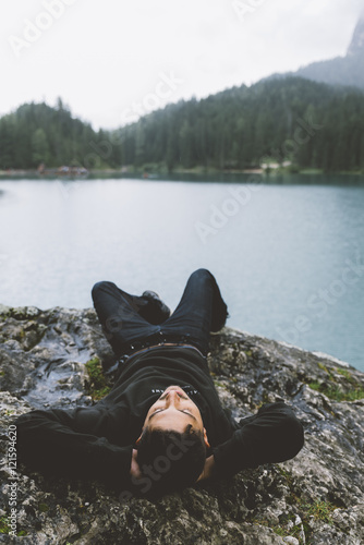 Man relaxing on a cliff on ...