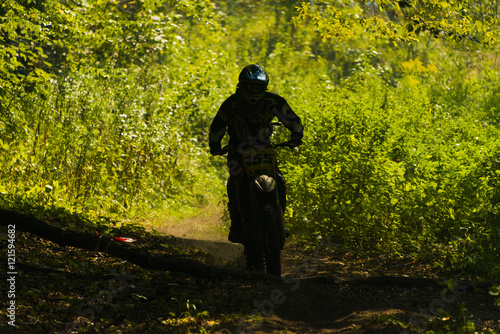 Unknown racer overcomes the track in the forest