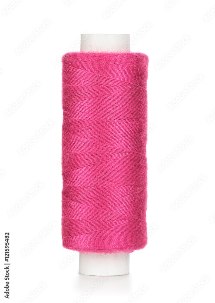 Pink spool of thread isolated on white background. Closeup Pink spool of thread isolated on white background. Closeup