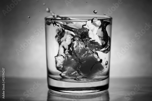 Ice Dropped Into Glass of Water from height making a splash