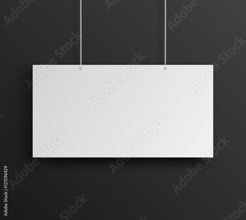 Blank white horizontal poster hanging on black wall