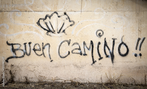 Buen Camino words and a shell painted on a wall on the way of Santiago