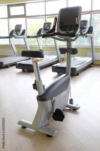 Interior of a fitness hall with sport bicycles and treadmills