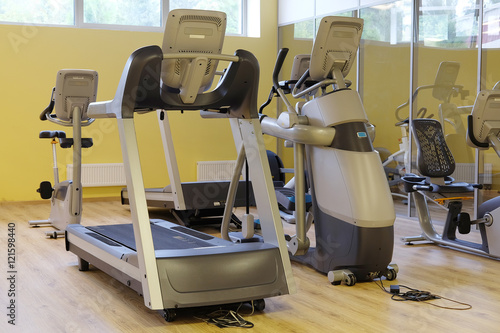 Interior of a modern fitness hall with treadmill