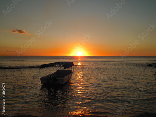 sun set on the sea with a boat