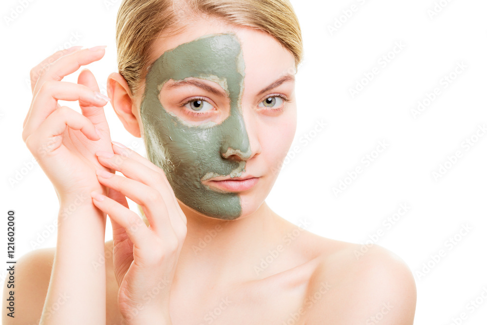 Woman in clay mud mask on face isolated on white. Woman in clay mud mask on face isolated on white.