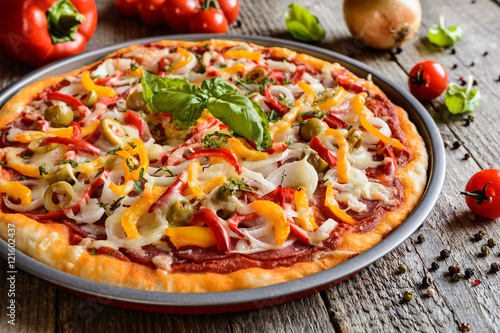 Salami pizza with green olives, pepper, onion and Edam cheese