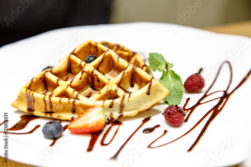 Viennese waffles drizzled with chocolate sauce  berries on a