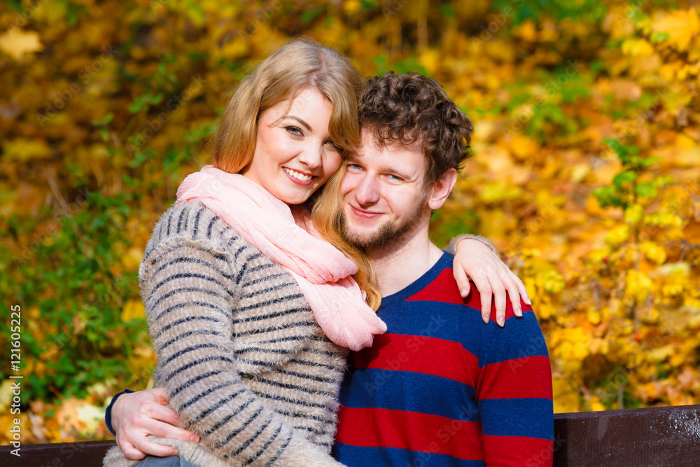 Lovers couple in autumn park on bench Lovers couple in autumn park on bench