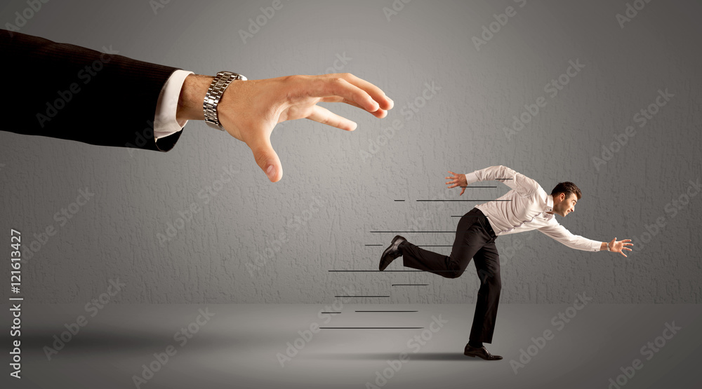© ra2 studio - Businessman running away from a huge hand © ra2 studio - Businessman running away from a huge hand