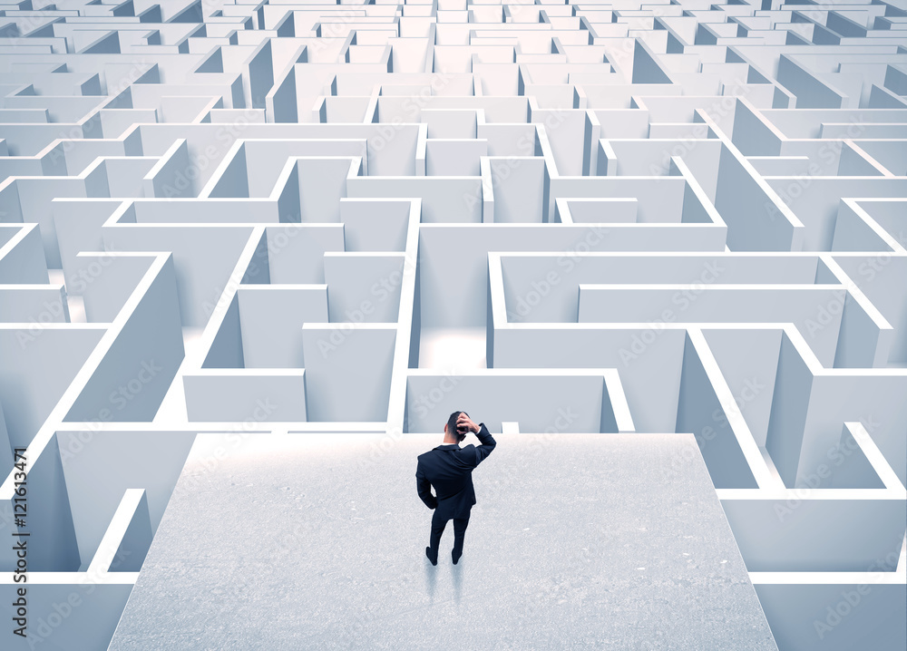 Businessman staring at infinite maze Businessman staring at infinite maze