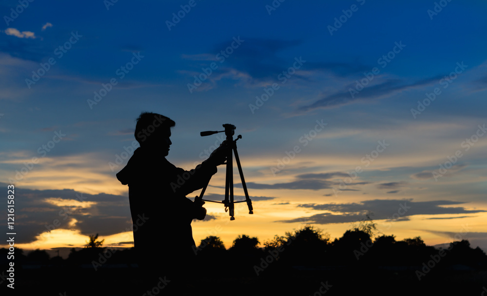 Photographer silhouette with blue sunset sky