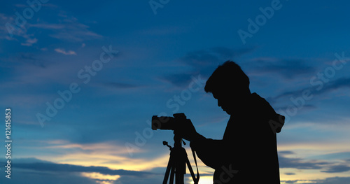 Photographer silhouette with blue sunset sky