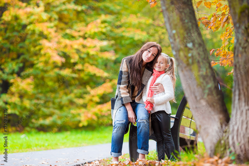 Happy mom with little girl on beautiful autumn day Happy mom with little girl on beautiful autumn day