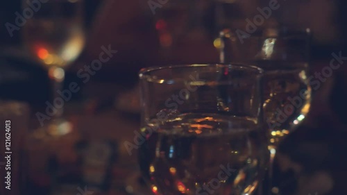 Restaurant or bar table with plate of appetizers and wine. Wine pouring in the glass. 4k. 3840x2160