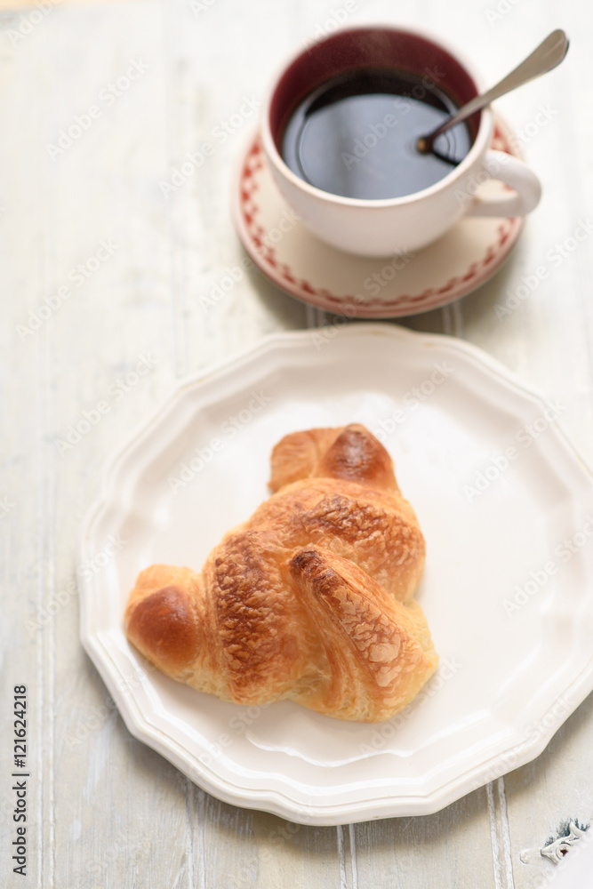 Croissant and coffee cup