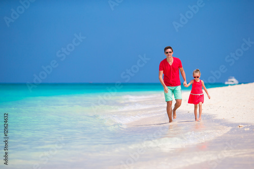 Happy family having fun on white tropical beach
