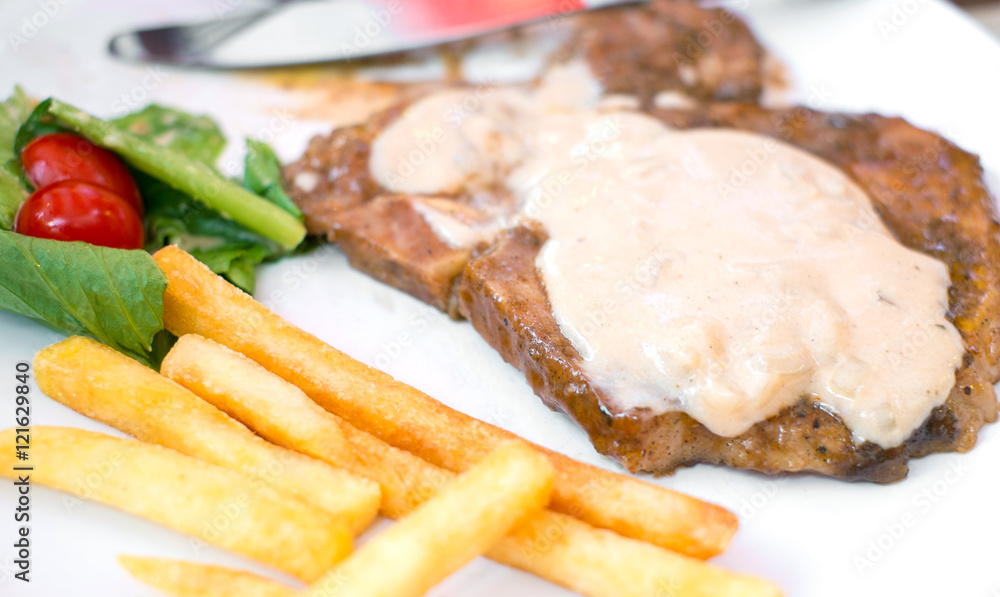 porkchop steak, frenchfried and salad porkchop steak, frenchfried and salad