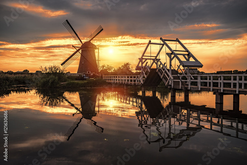 Beautiful sunset over the Unesco world heritage windmill at the other side of the canal protected by a movable bridge, Alblasserdam, Netherlands