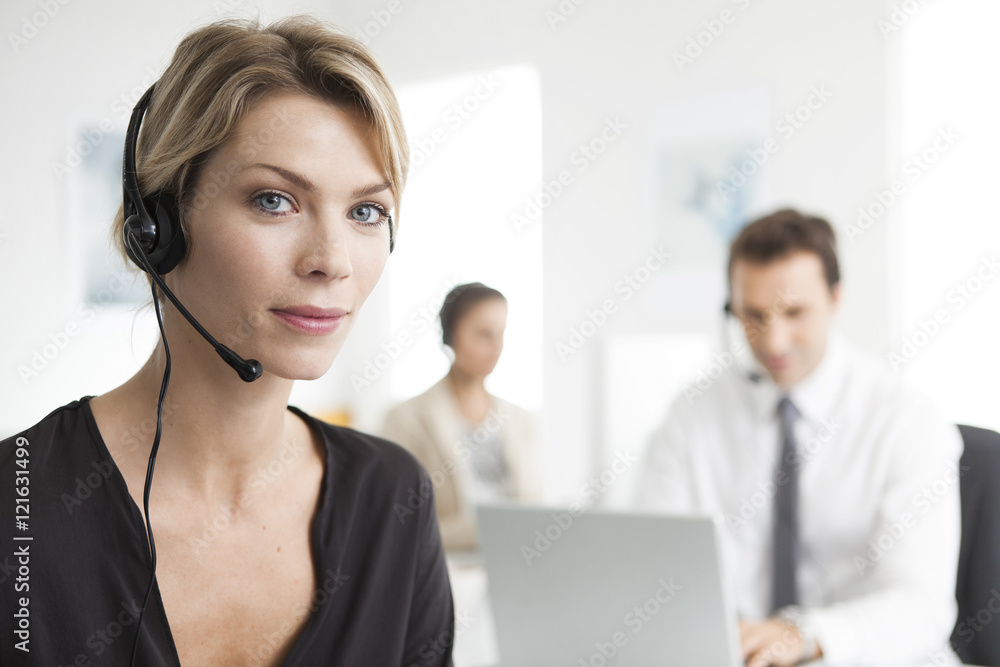 Businesswoman wearing headset working in office