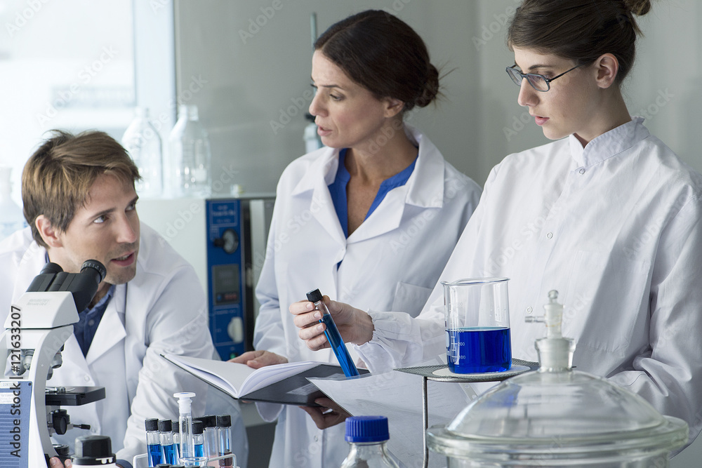 Scientists experimenting in a laboratory Scientists experimenting in a laboratory