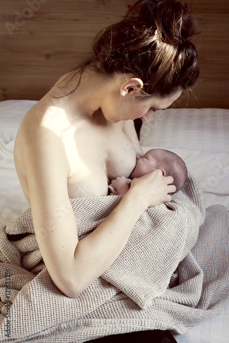Mother breastfeeding newborn baby