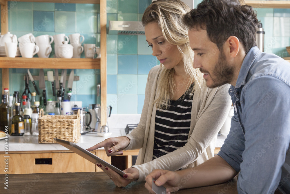 Couple using digital tablet to shop online Couple using digital tablet to shop online