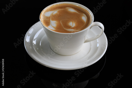 coffee cup on black background with reflection