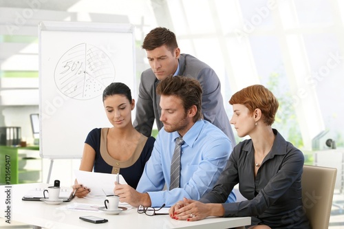 Business team reading papers at office meeting