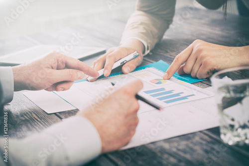 Male hand pointing at business document during discussion at mee