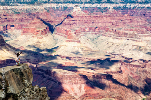Woman standing before the Grand Canyon