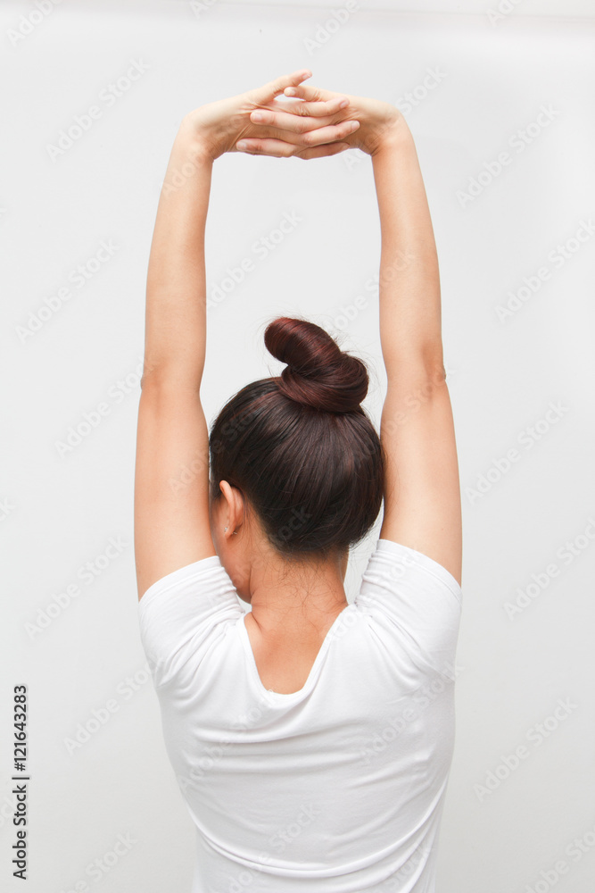 Fototapeta premium Back view portrait of a young woman stretching hands on white background