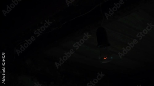Flashing lightbulb In the old basement of the house