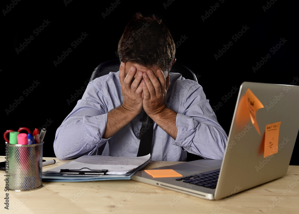 tired businessman suffering work stress wasted worried busy in office late at night with laptop computer tired businessman suffering work stress wasted worried busy in office late at night with laptop computer