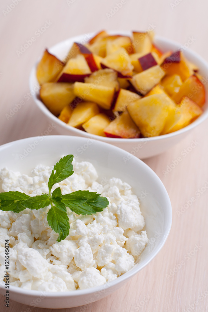 Photo of curd dessert with peaches and mint leaf Photo of curd dessert with peaches and mint leaf