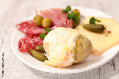 raclette cheese melted with potato and meats