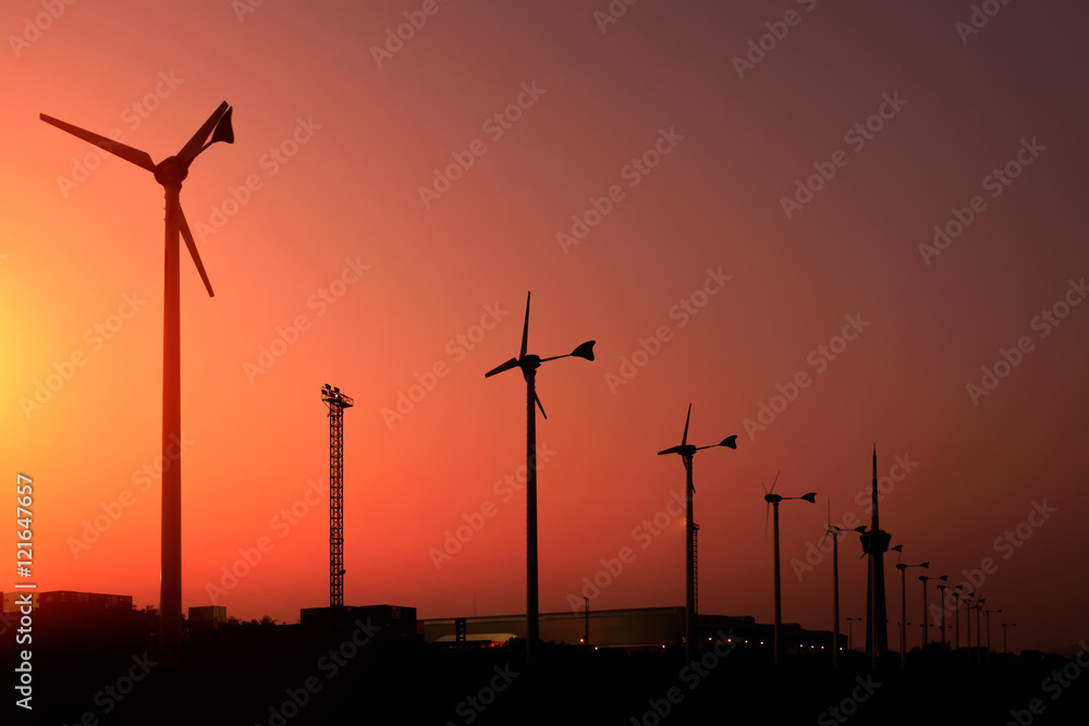 Obraz premium silhouette of wind turbine generating electricity on sunset.