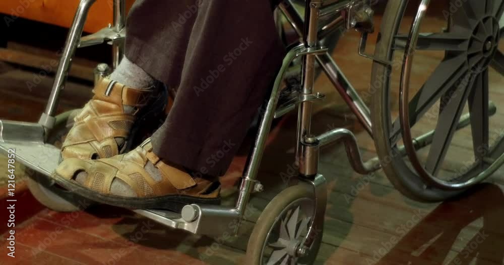 Close-up of legs of a disabled man in a wheelchair Close-up of legs of a disabled man in a wheelchair