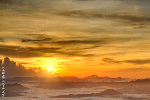 Beautiful golden sky over the layers of hill with sea of fogs