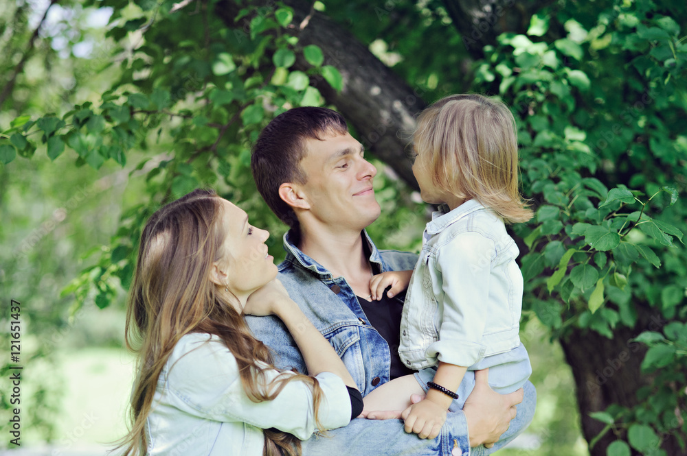 Fototapeta premium Family - mom, dad and little daughter on nature.