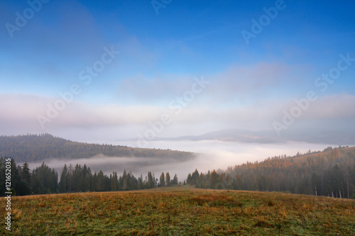 Autumn September foggy morning in mountains