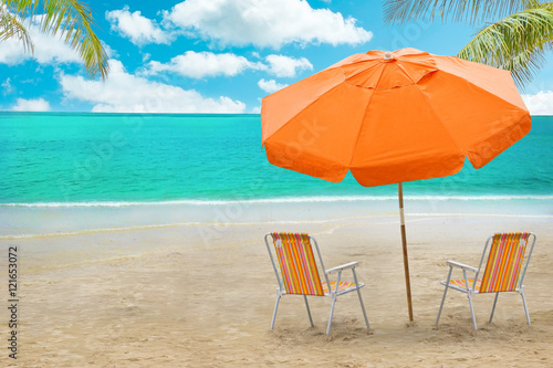 
Chaise lounge and umbrella on beach