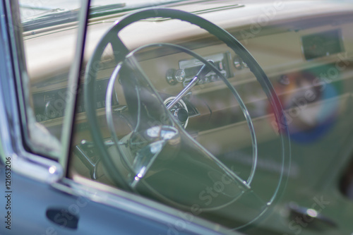 Old car with radio. In the glass the reflection of the street. An American classic. Retro. © zhdanovdi