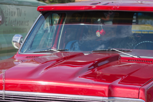 Red retro car. The view from the side. Chrome lining. An American classic. © zhdanovdi