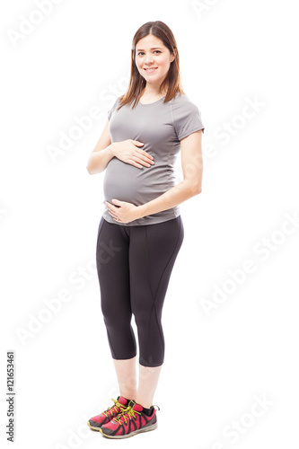 Cute pregnant woman in sporty outfit