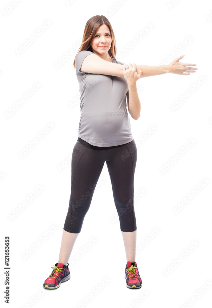 Pregnant woman doing stretching exercises Pregnant woman doing stretching exercises