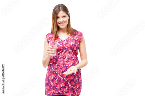 Pregnant woman taking some vitamins